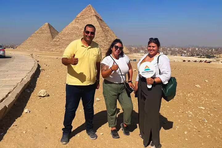 Tour guests posing at Giza Pyramids viewpoint during Cairo layover tour to pyramids, Memphis and Sakkara