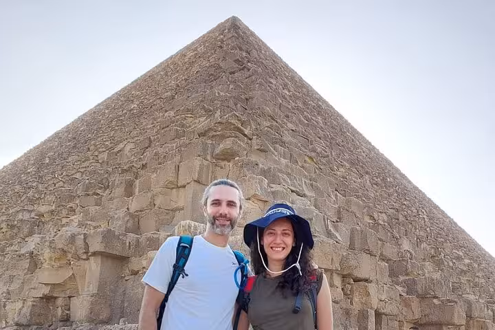 Couple at Great Pyramid of Giza during Cairo airport layover tour, private transfer and Egyptologist guide