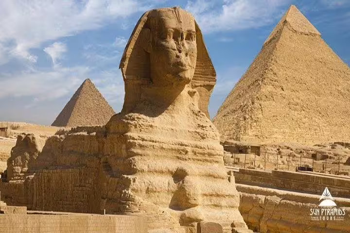 Great Sphinx with Giza Pyramids under blue sky, highlight of 5 days Cairo to Luxor Egypt tour