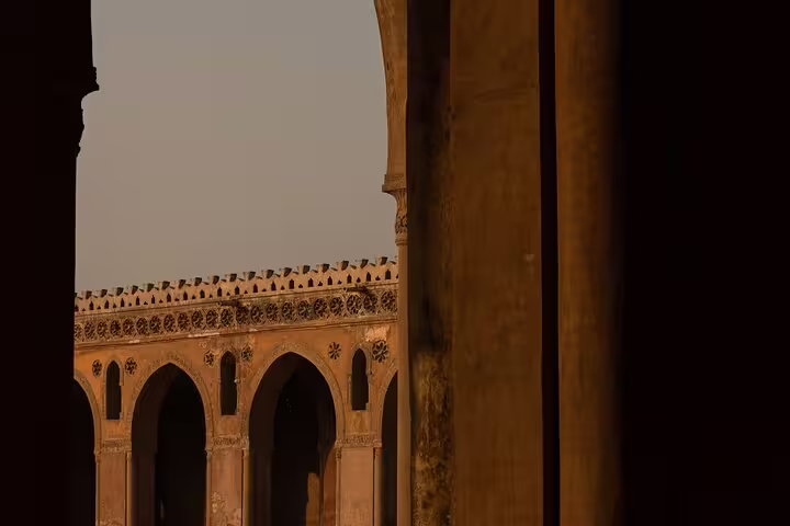 Arched corridor of Cairo mosque at sunset, Islamic architecture on Citadel and Bazaar guided tour