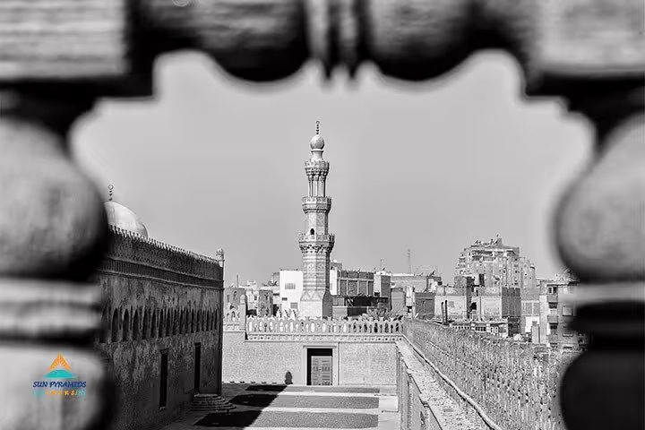 Minaret view through stone archway at Cairo Citadel mosque complex, highlight of historical Cairo mosques tour