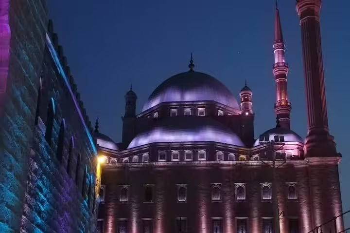 Illuminated Cairo mosque at night with grand dome and minaret, featured on Four Seasons luxury tour