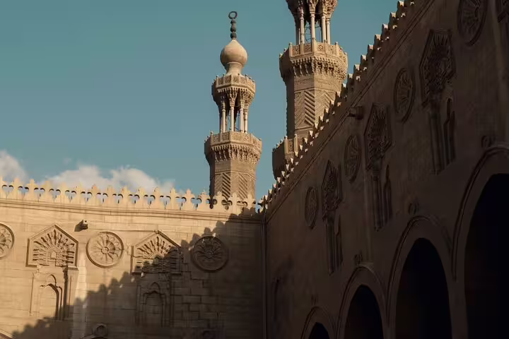 Ornate minarets and carved stone walls in Islamic Cairo, featured on the Citadel, Bazaar and Cairo Mosques Tour