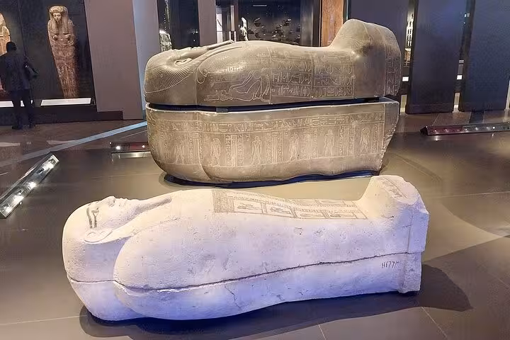 Ancient Egyptian sarcophagi with hieroglyphs at Cairo Museum, highlight of Hurghada to Cairo Pyramids and Sphinx tour