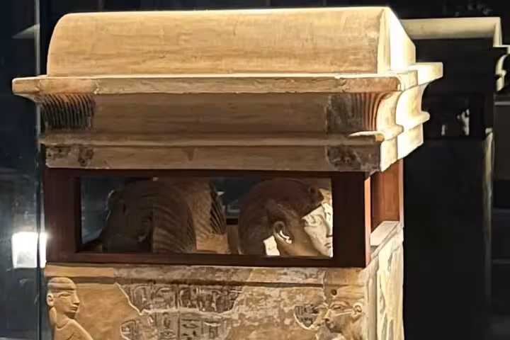 Decorated ancient Egyptian sarcophagus exhibit at Cairo National Museum of Egypt, scan QR ticket to enter