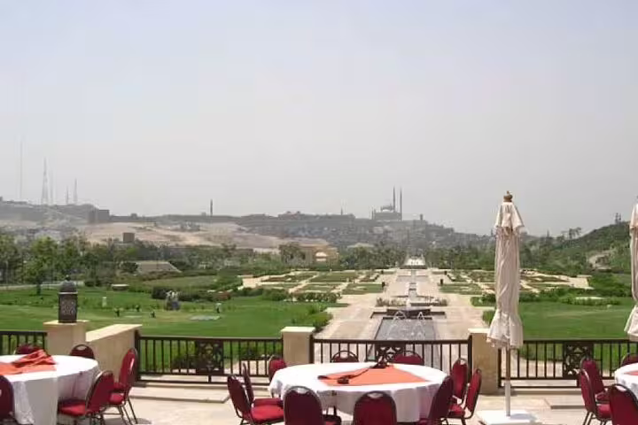 Outdoor terrace dining overlooking Al Azhar Park gardens, part of Cairo by Night tour with dinner views