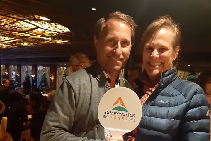 Guests pose inside Al Fishawi Cafe on Cairo by night tour, exploring Khan El Khalili’s historic atmosphere