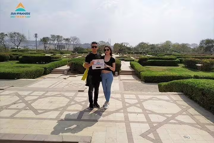 Guests pose in El Azhar Park gardens on a Cairo by night tour with dinner and ElFishawy Cafe visit