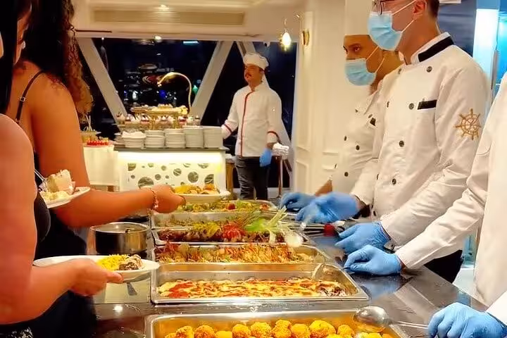 Buffet station on Cairo Nile dinner cruise with chefs serving hot dishes, a popular evening boat tour