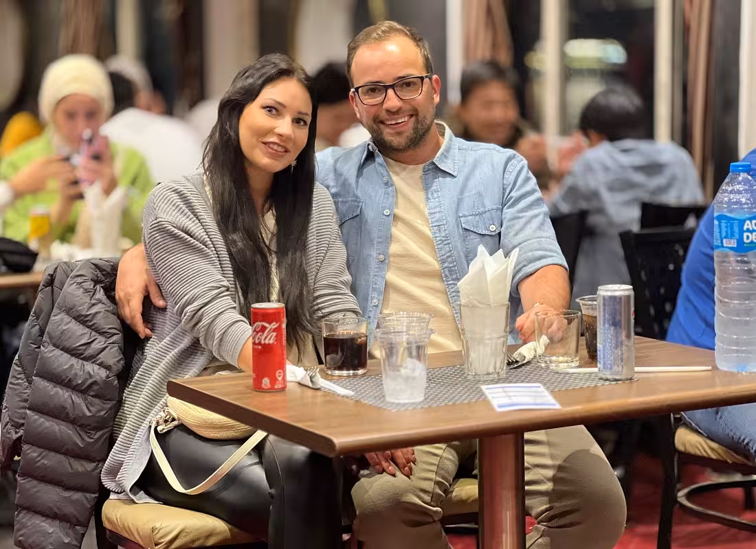 Couple dining on a Cairo Nile dinner cruise with belly dancing show, buffet dinner, and hotel pickup and drop-off