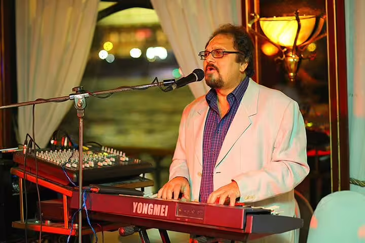 Live singer and keyboardist performing on Cairo Nile dinner cruise, evening add-on to Egyptian Museum and Citadel tour