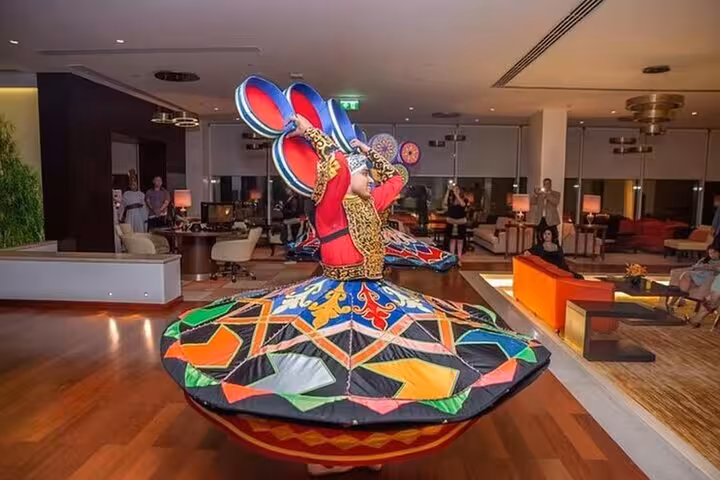 Tanoura dancer spinning in colorful skirt during Cairo Nile dinner cruise, traditional show entertainment onboard