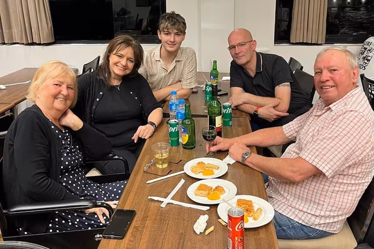 Guests enjoy dinner and drinks on a Cairo Nile dinner cruise with transfer, seated at a dining table