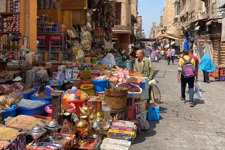Cairo Old City market street with spice stalls and local vendors, a hidden gems food and culture tour stop
