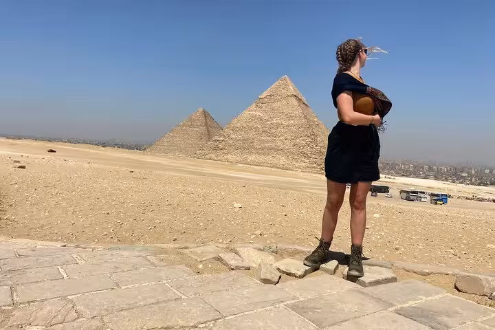 Traveler standing near Great Pyramid of Giza on Cairo private tour, desert panorama and Egyptian lunch stop