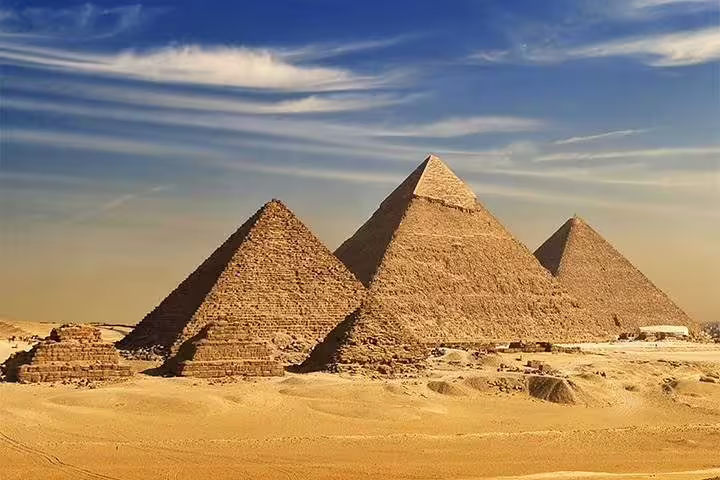Great Pyramids of Giza under blue sky, iconic backdrop for Cairo photo session add-on tour in Egypt