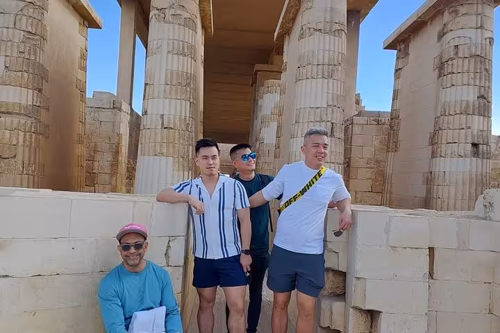 Travelers at Saqqara Step Pyramid complex columns, a highlight of the Cairo 2-day pyramids tour
