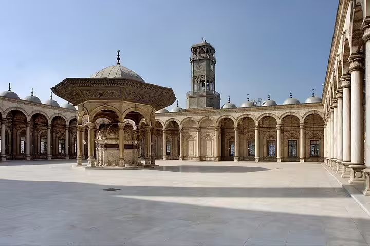 Cairo short break tour view of Mohamed Ali Mosque courtyard with ornate ablution fountain and minaret