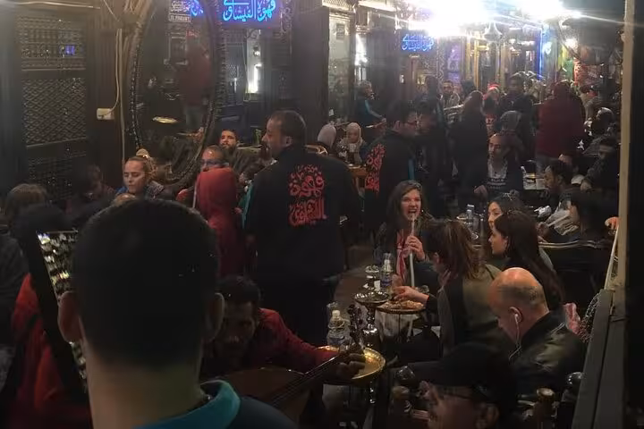 Crowded Cairo street café with shisha and tea, a lively stop on an Egyptian food and tea tour