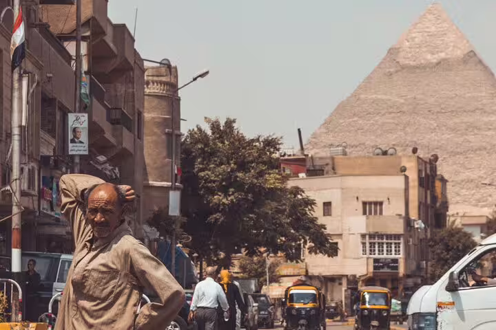 Cairo street scene with Giza Pyramid in the distance, authentic local view on royal Giza Saqqara Dahshur tour