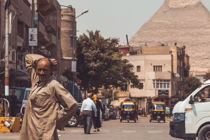 Cairo street photo session with local scene and Giza Pyramid backdrop, ideal add-on tour photography stop