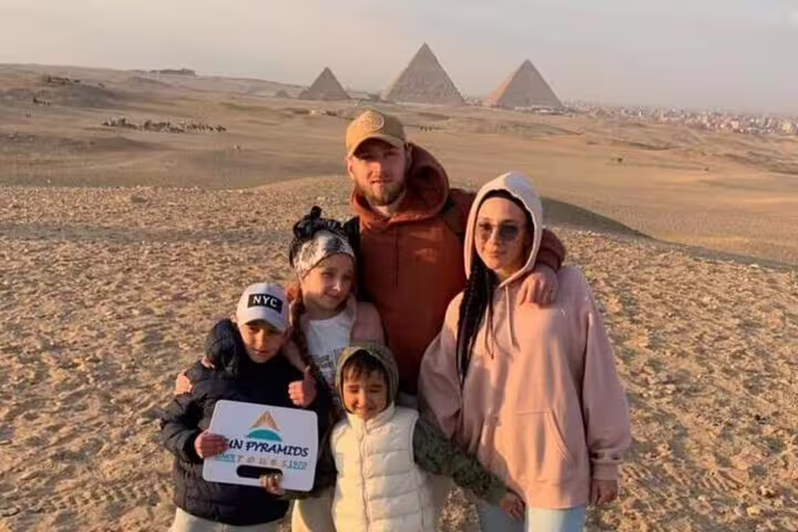 Family photo at Giza Plateau with the Great Pyramids, perfect for Cairo 3-day highlights tour