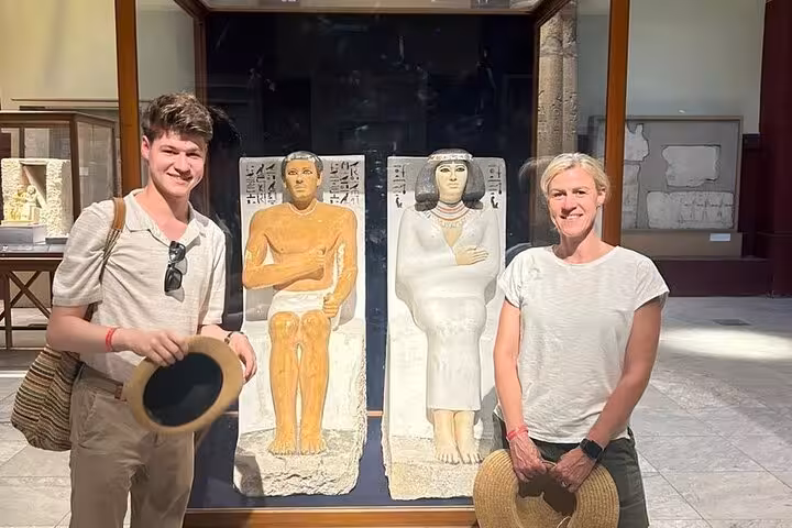 Visitors at the Grand Egyptian Museum viewing ancient statues, part of a Cairo 2-day tour with GEM
