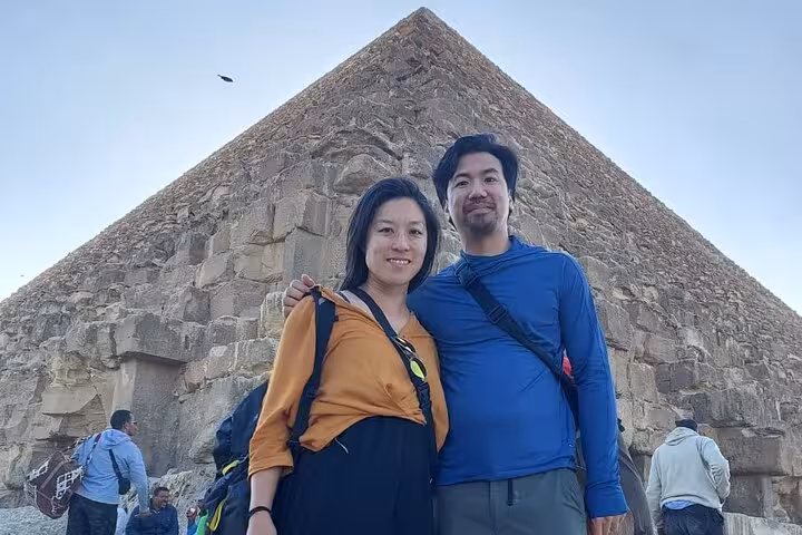 Travelers pose at the Great Pyramid of Giza on a 3-day all-inclusive Cairo tour with guided sightseeing
