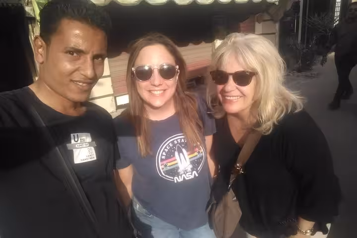 Happy guests with Cairo tour guide in Khan El Khalili bazaar during 2-day Pyramids and GEM itinerary