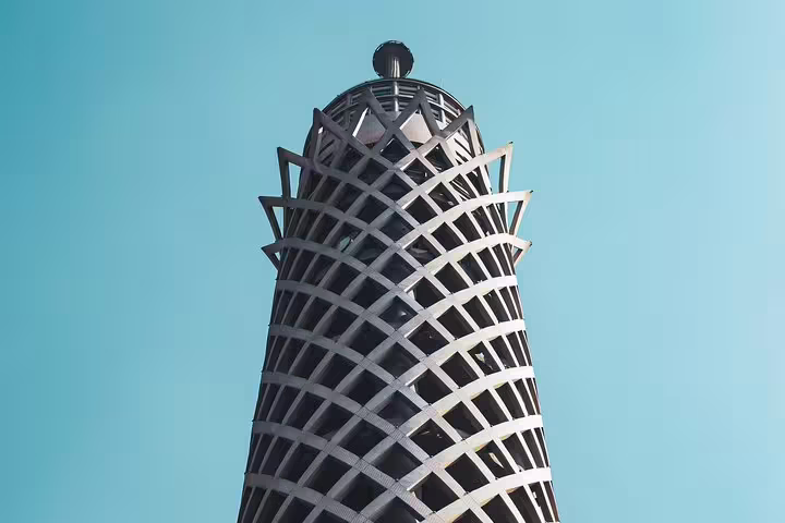 Close-up of Cairo Tower lattice crown against blue sky on a day tour to Manial Palace and Cairo Tower