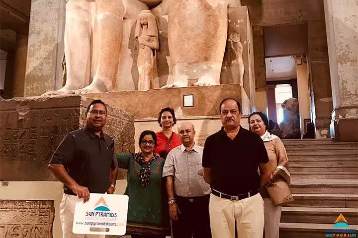 Travelers at the Egyptian Museum Cairo with colossal statues, part of a 5-day Cairo vacation package tour