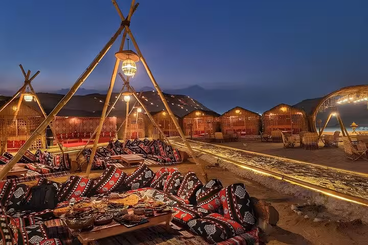 VIP Arabian Night in Giza with Bedouin dinner table, traditional seating and warm lantern-lit desert camp ambiance