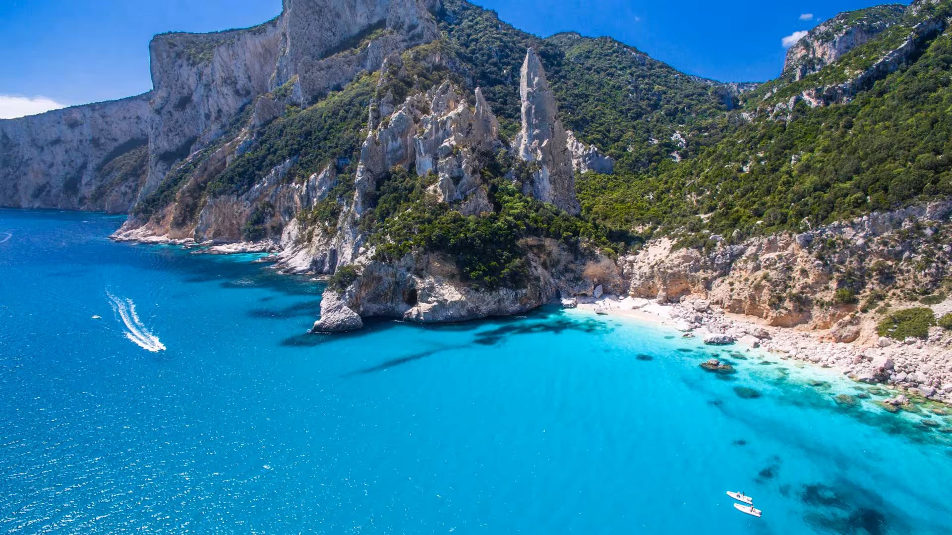 Aerial view of Cala Gonone's stunning cliffs and turquoise waters in the Gulf of Orosei, perfect for a boat tour.
