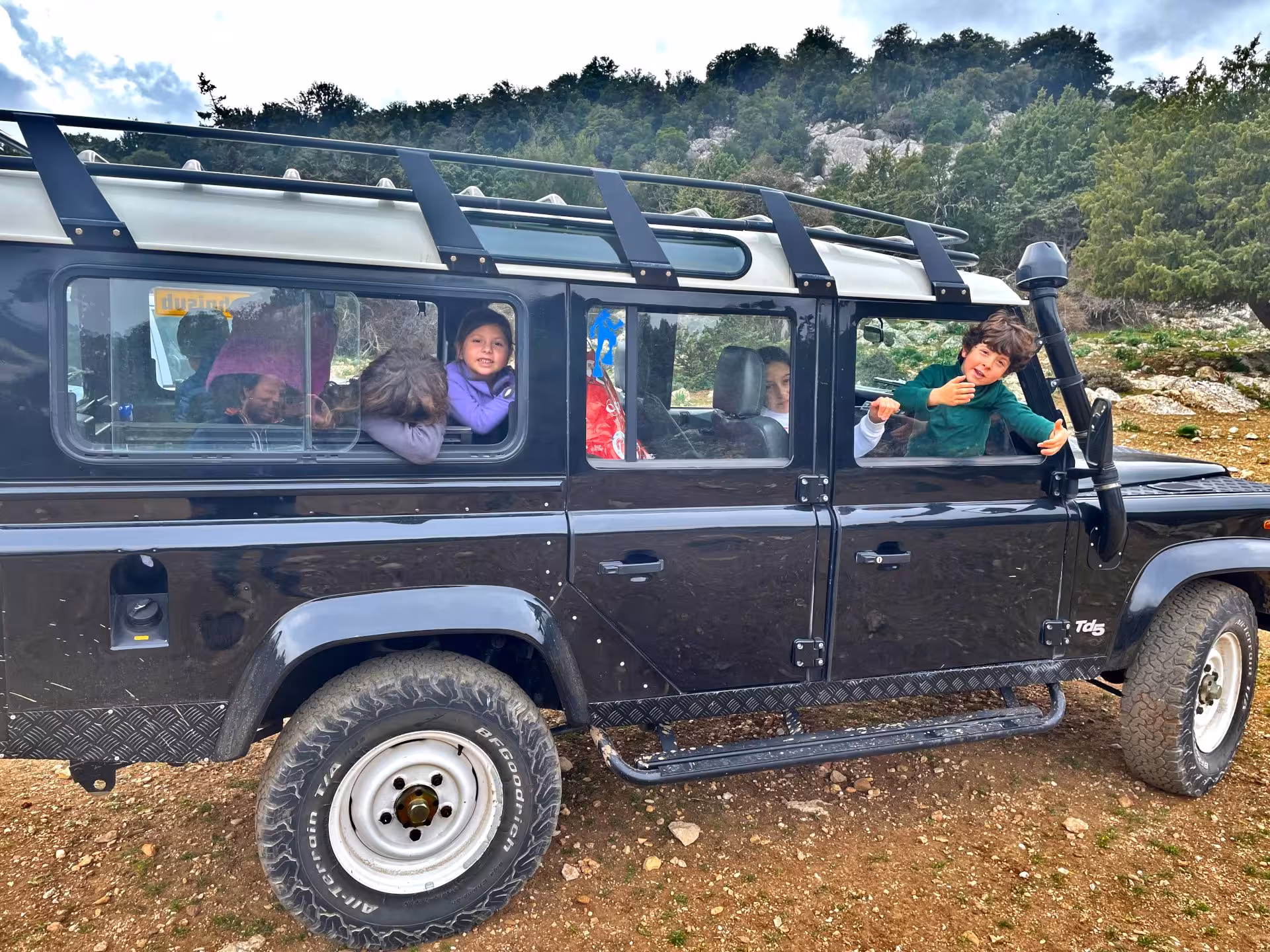 Children enjoying a jeep tour in Dorgali's rugged landscape, part of the Cala Gonone adventure.