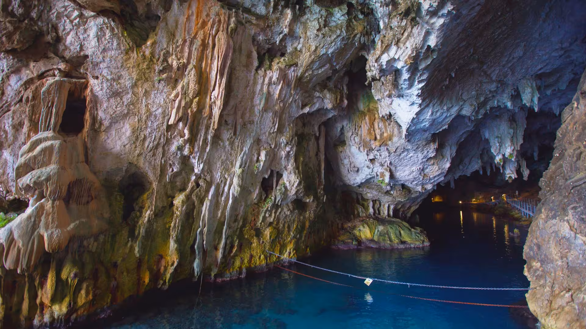 Discover the vibrant geological beauty of Bue Marino Caves with crystal-clear waters on a motorboat tour from Cala Gonone.