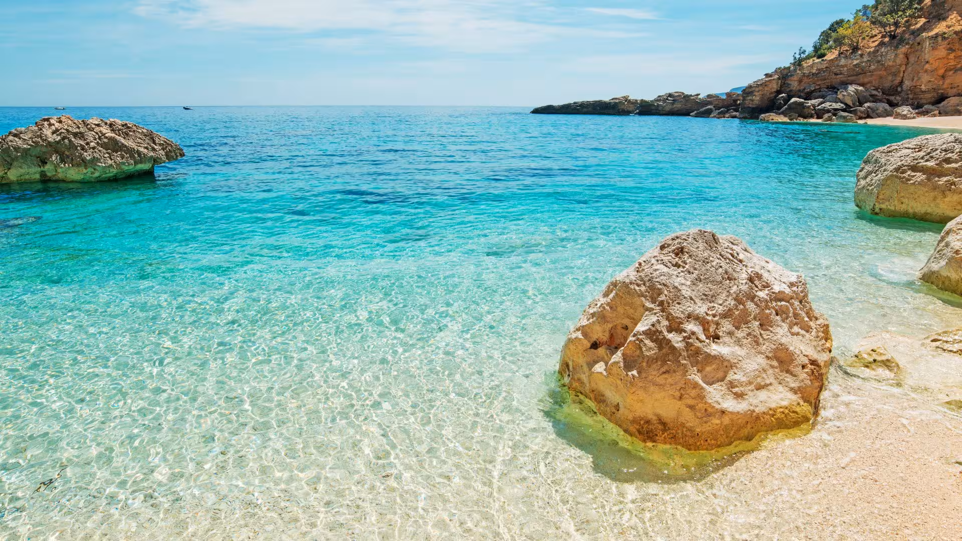 Crystal-clear waters and rocky shorelines in the Gulf of Orosei, perfect for a Cala Gonone boat tour adventure.