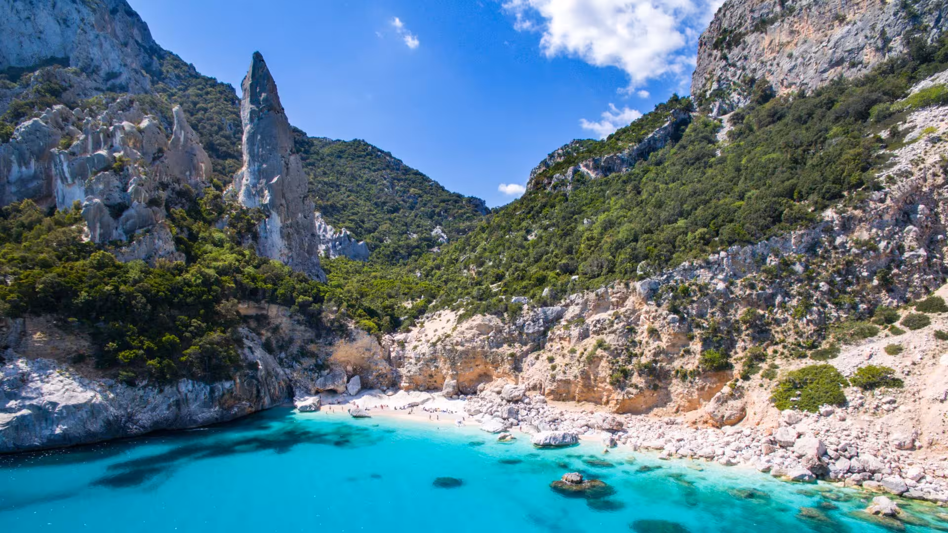 Scenic view of Cala Gonone's turquoise waters and rugged cliffs, ideal for a 6-person RIB rental adventure.