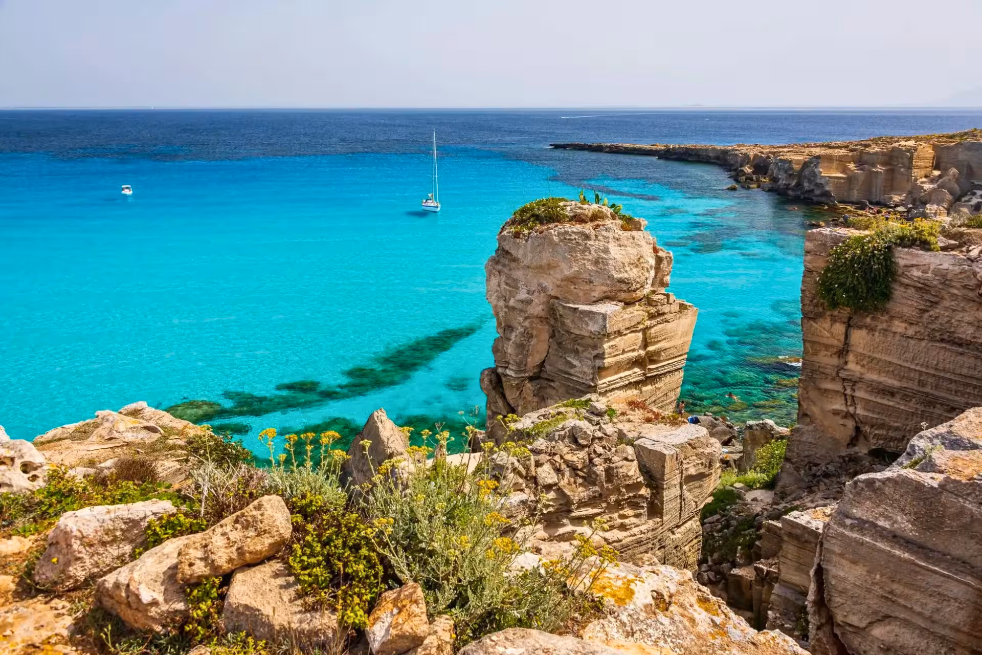 Cliffs above crystal-clear Cala Rossa, Favignana stop on Egadi Islands boat trip from Trapani with lunch