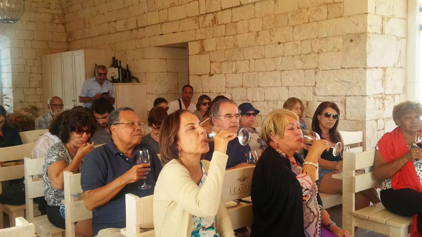 Guests enjoy a guided wine tasting in a rustic stone winery during The Intense Flavor of Calabria 8-day self-drive food tour