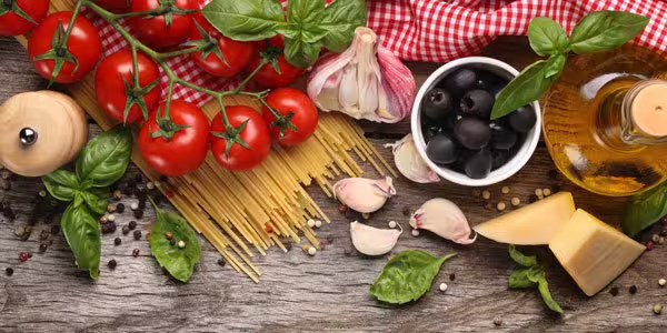 Fresh Italian ingredients for Calabrian cuisine in Cosenza, with tomatoes, pasta and olive oil on a rustic table near Sila and Tyrrhenian coast