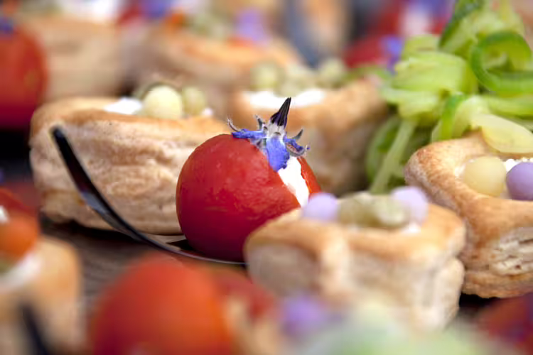 Gourmet Calabrian finger food with stuffed cherry tomato and delicate pastries served during VIP castle stay