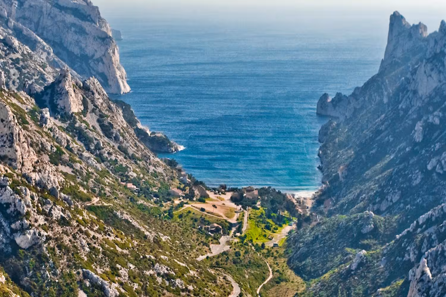 Panoramic view to Calanque de Sormiou beach from limestone cliffs, a scenic Marseille Calanques day tour