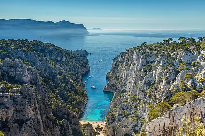 Breathtaking Calanques of Cassis showcasing azure waters and dramatic cliffs, ideal for a village and wine tasting tour.