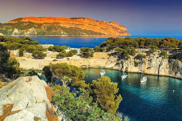 Stunning view of Calanques of Cassis with turquoise waters and rugged cliffs, perfect for a private tour.