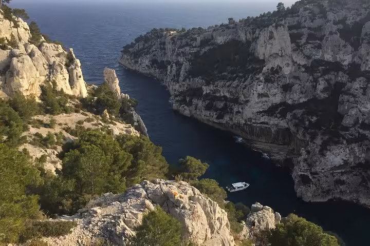 Calanques National Park near Marseille, Provence, with limestone cliffs and a boat on turquoise inlet