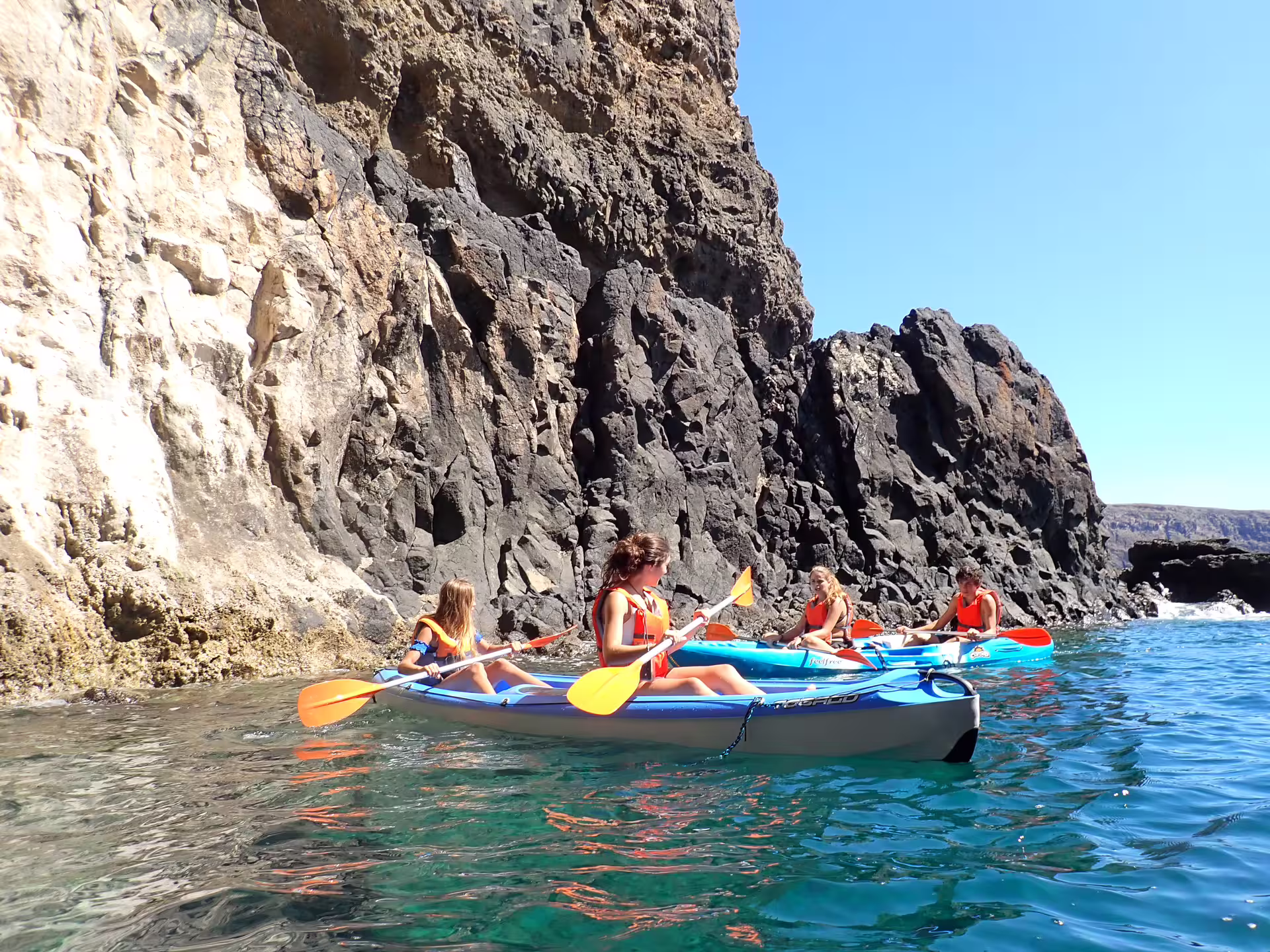 Kayakers explore stunning cliffs and crystal-clear waters on the scenic Calheta Kayak Tour, perfect for adventure seekers in Madeira.