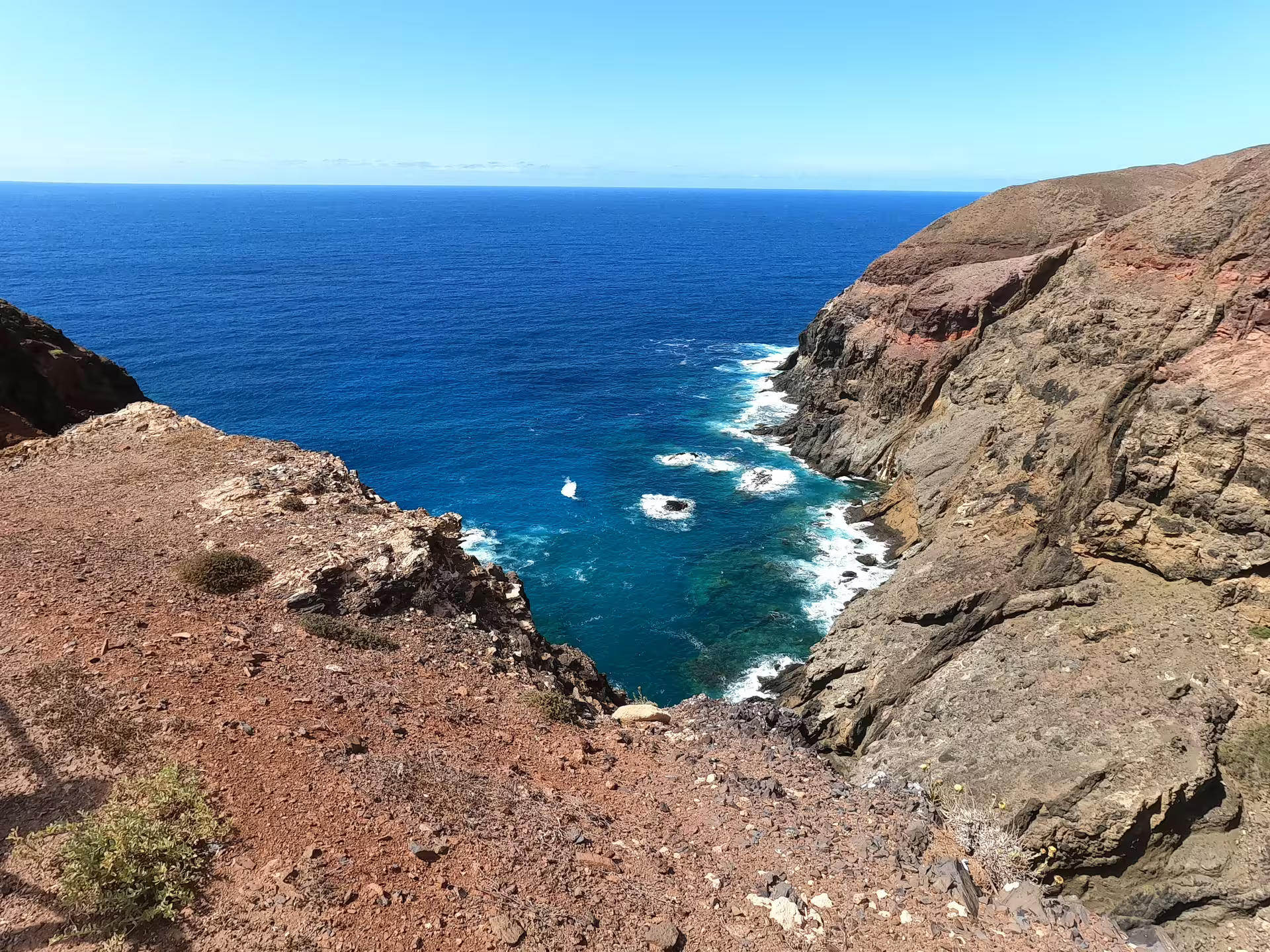 Breathtaking view of Calheta's rugged southwest coastline with azure waters and rocky cliffs, perfect for a scenic van tour.