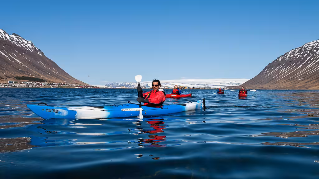 Small group calm water kayaking in a scenic fjord, easy paddling with mountain views and stable sit-in kayaks