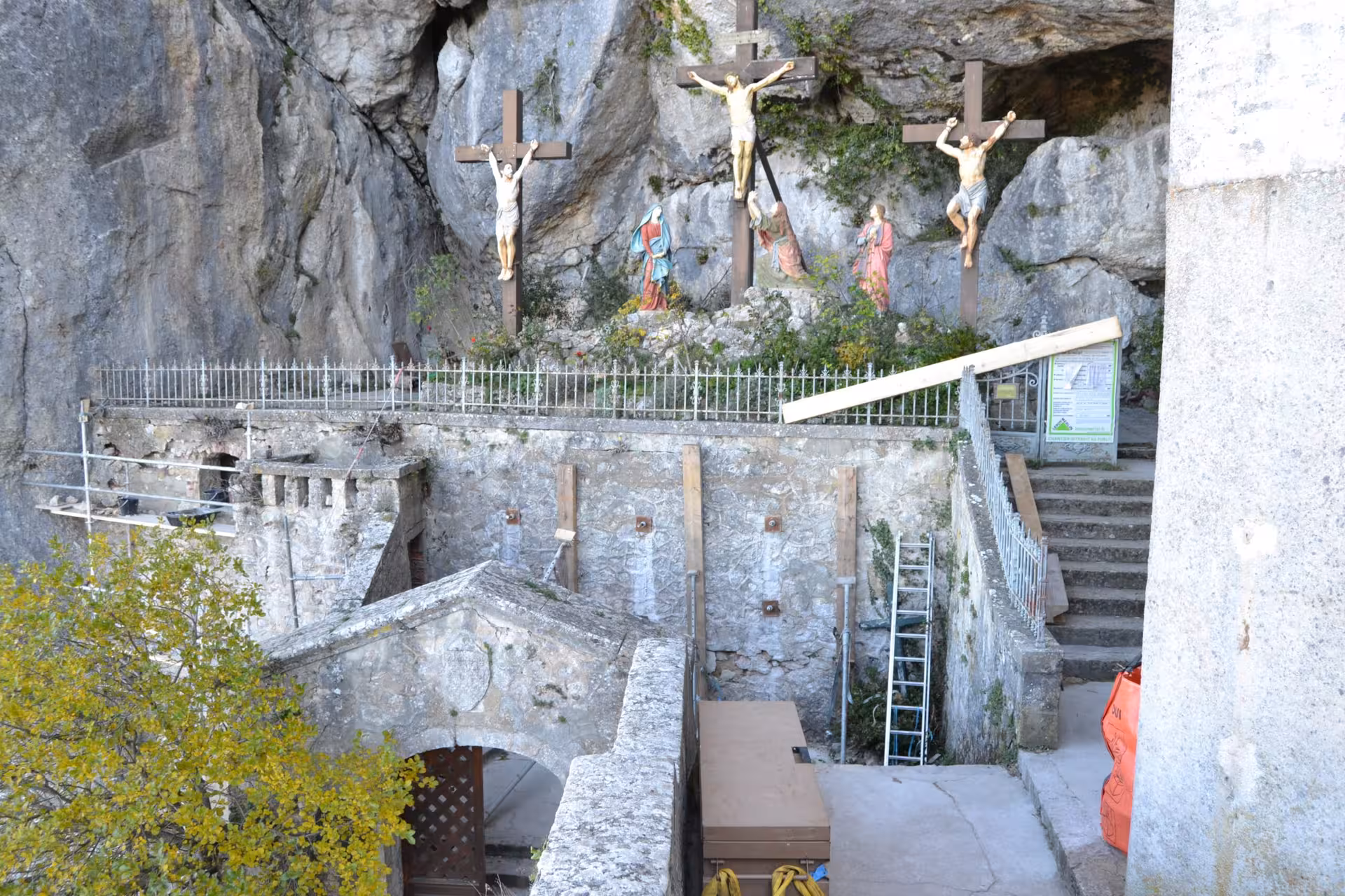 Calvary statues at the cliffside entrance near Grotte Sainte-Madeleine on a sacred hike in Provence, France