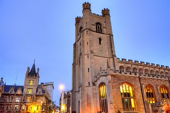 Illuminated Cambridge historic tower and Gothic architecture at dusk, featured on a self-guided scavenger hunt tour